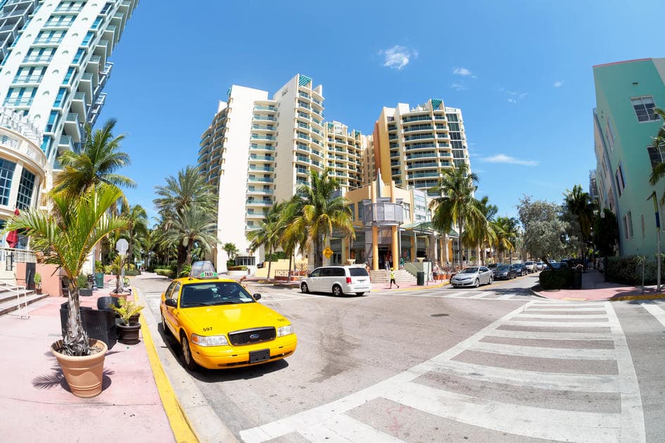 Taxi in Miami: a photo of a yellow taxi on Ocean Drive in Miami Beach - American Butler