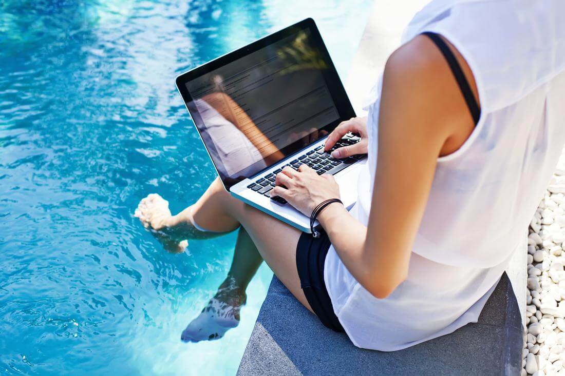 American Credit score and credit history — how to improve performance and raise points — photo of a girl at the computer at the pool — American Butler