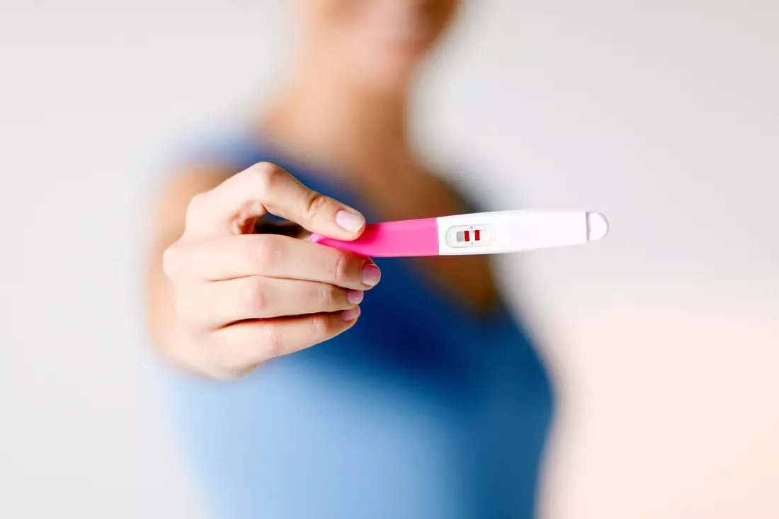 Woman with positive pregnancy test after IVF procedure in Miami