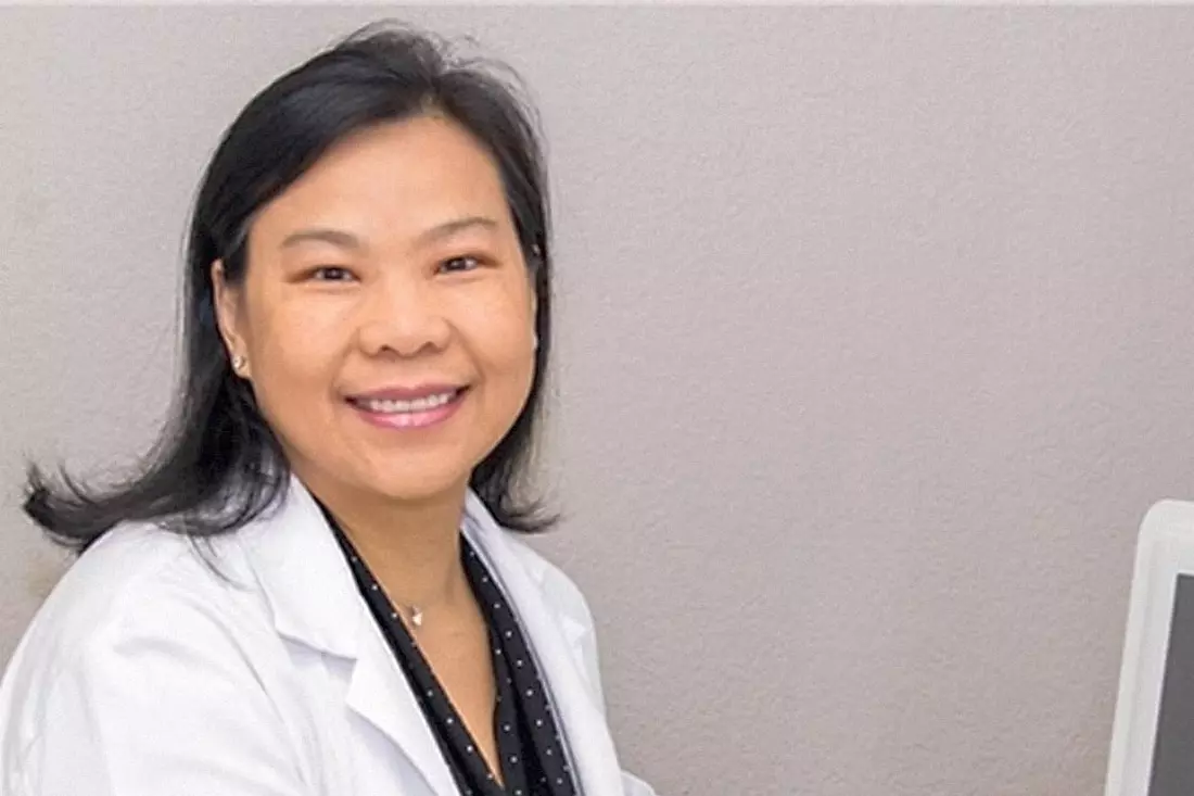 Pictured is a smiling woman in a white medical coat, Dr. Alicia Acon