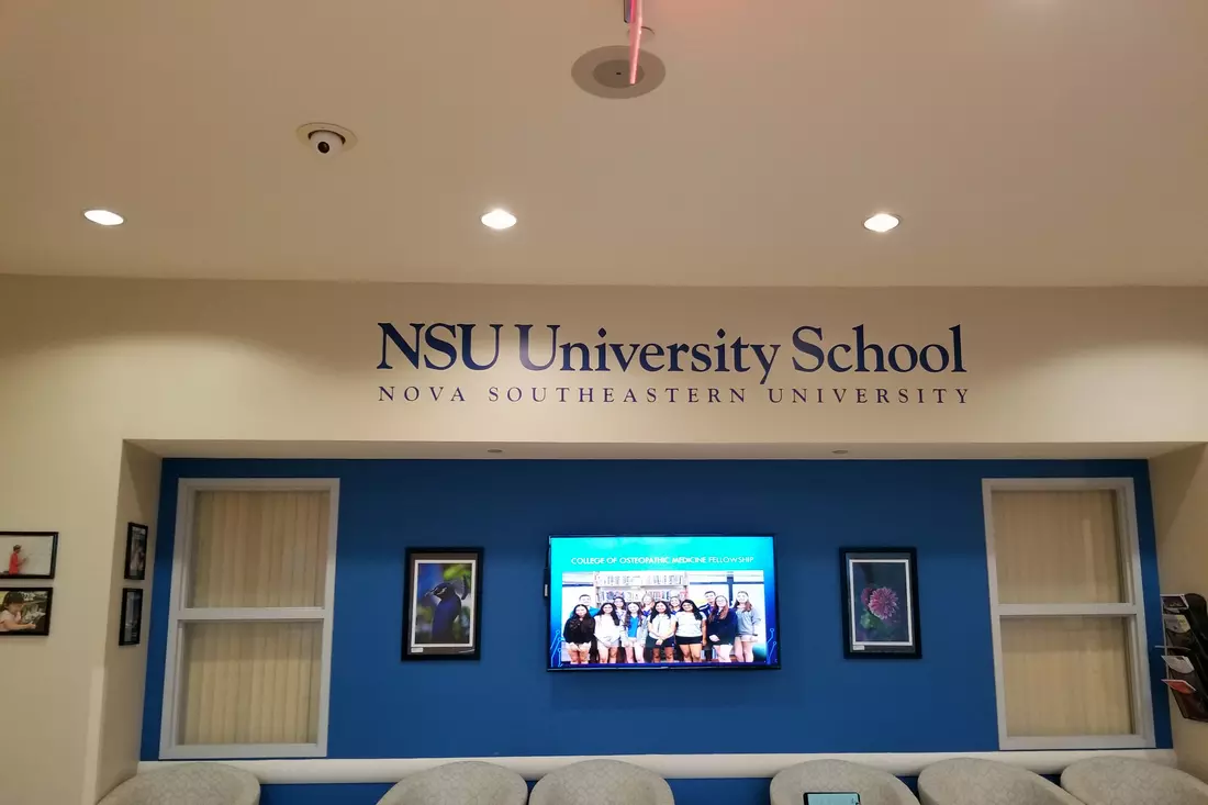 Interior of NSU University School with logo on the wall