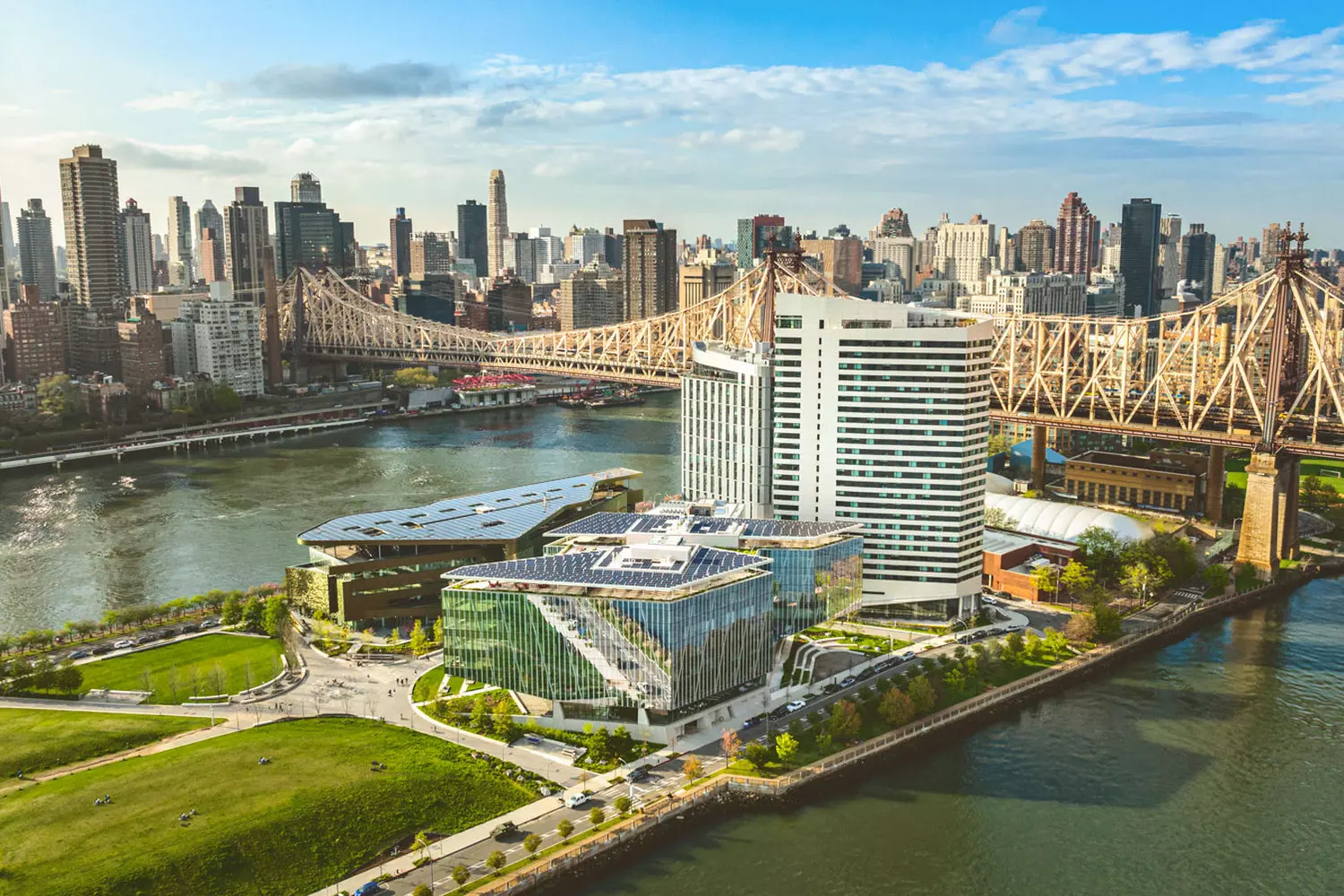 Современная устойчивая архитектура Блумберг Центра в кампусе Корнелл Тех на острове Рузвельта с видом на силуэт Манхэттена