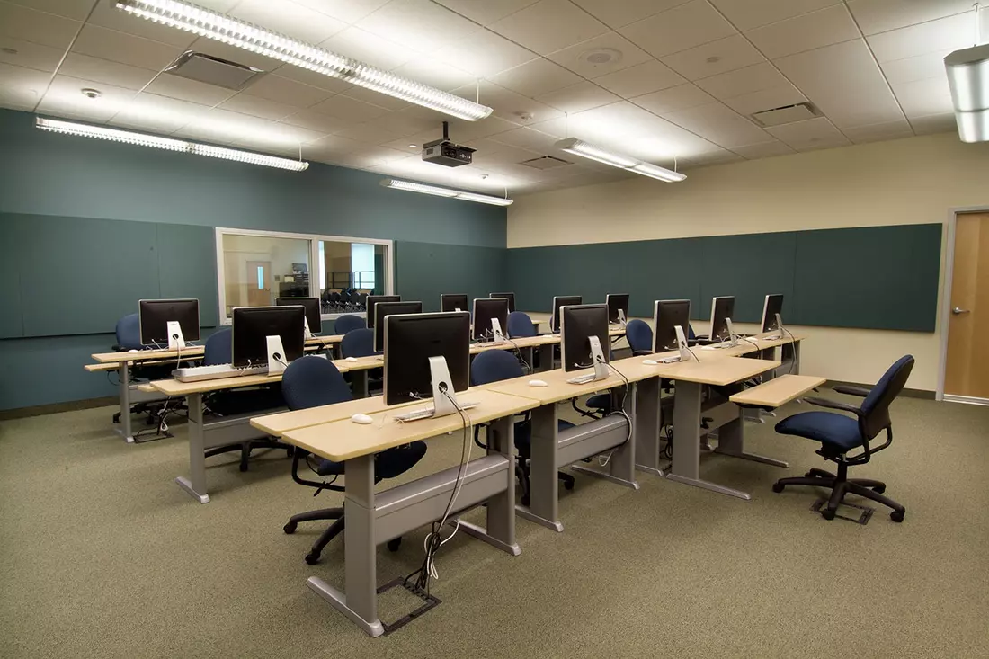 Modern Lecture Hall at Nova Southeastern University A modern, spacious lecture hall at Nova Southeastern University with tiered seating, advanced audio-visual equipment, and students attending a class