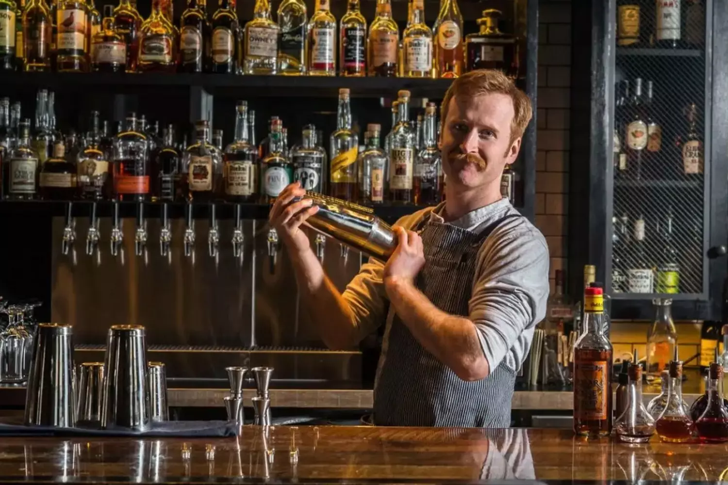 Premium Bartending Services in Miami — Craft Cocktails & Stunning Mixology Professional bartender mixing cocktails at a vibrant Miami bar, offering top-notch drink services with a tropical vibe