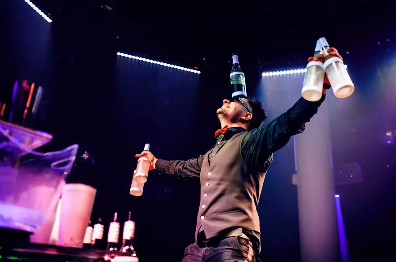 Miami Show Bartender — Spectacular Bottle Juggling & Expert Cocktail Crafting Talented bartender in Miami performing an impressive bottle juggling show while crafting cocktails with flair and precision