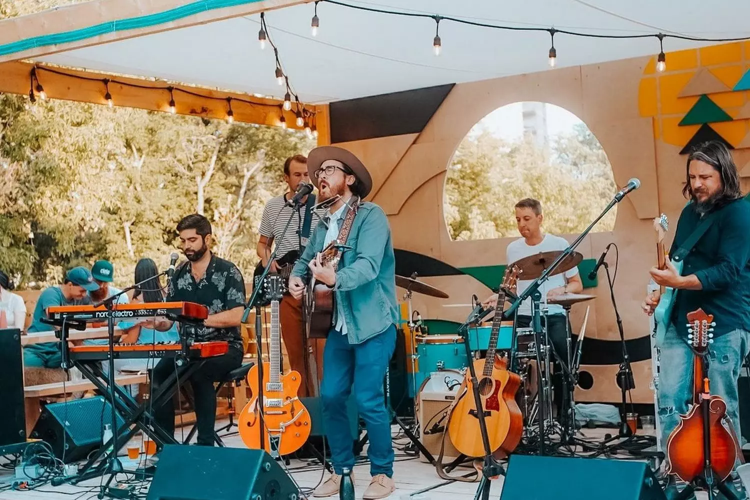 Premium Live Music Performances in Miami | Elevate Your Event with Professional Musicians Live band performing at a luxury Miami event with palm trees, sunset, and guests enjoying vibrant music by the ocean