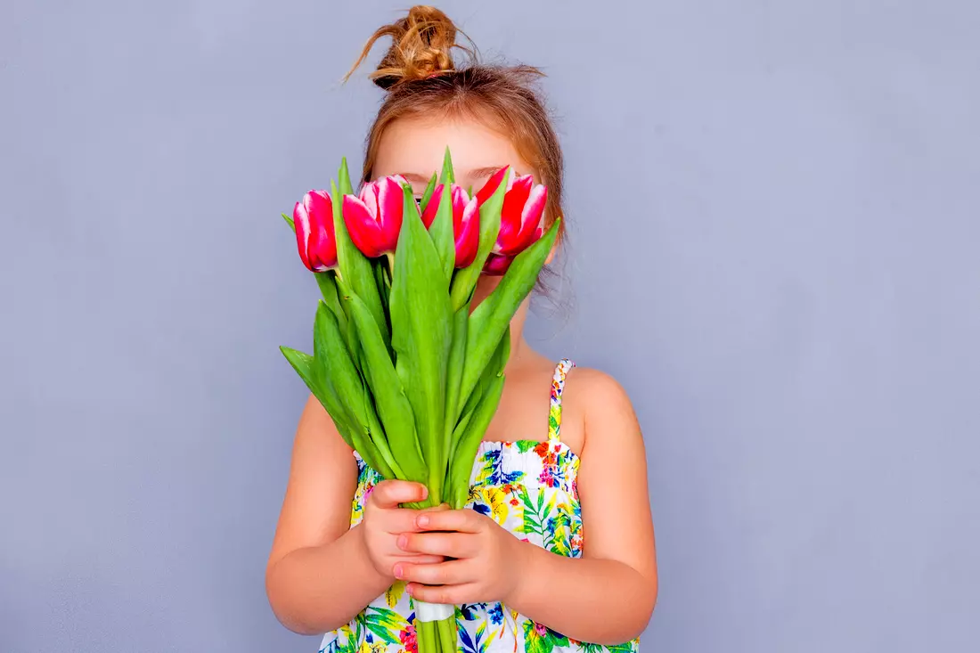 Photo of a girl with tulips in her hands — March 8th congratulations from American Butler