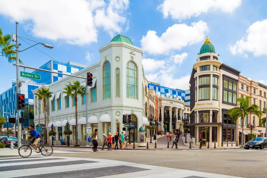 Rodeo Drive in Beverly Hills with luxury boutiques and palm trees lining the street