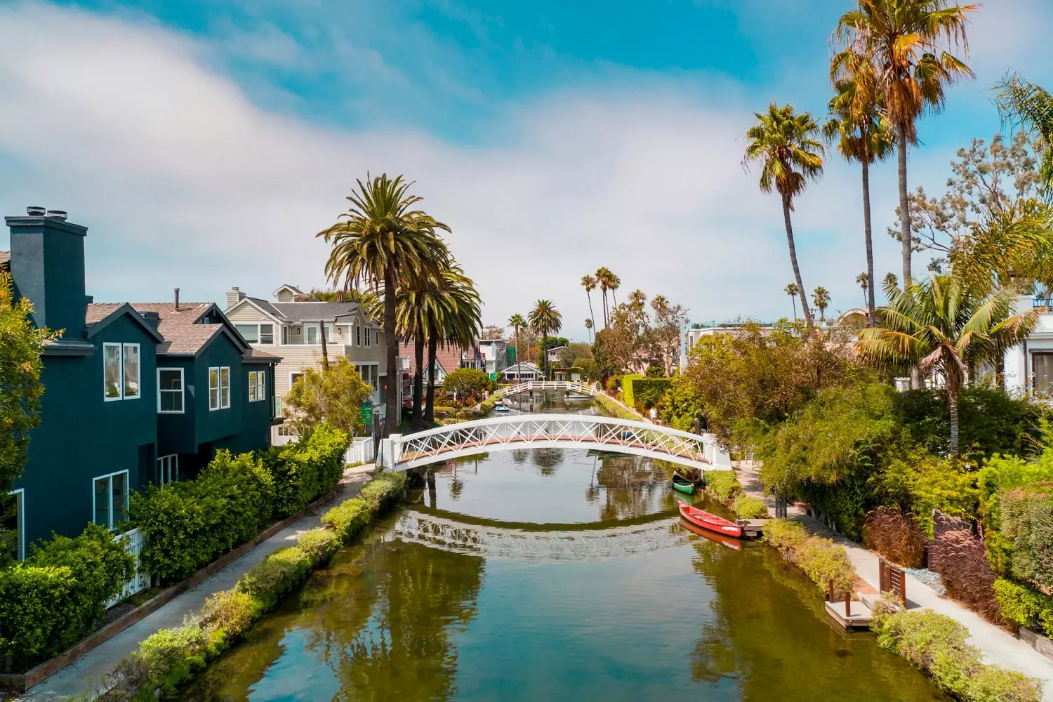 Живописный вид на Venice canals: узкий канал с лодкой и тропической растительностью