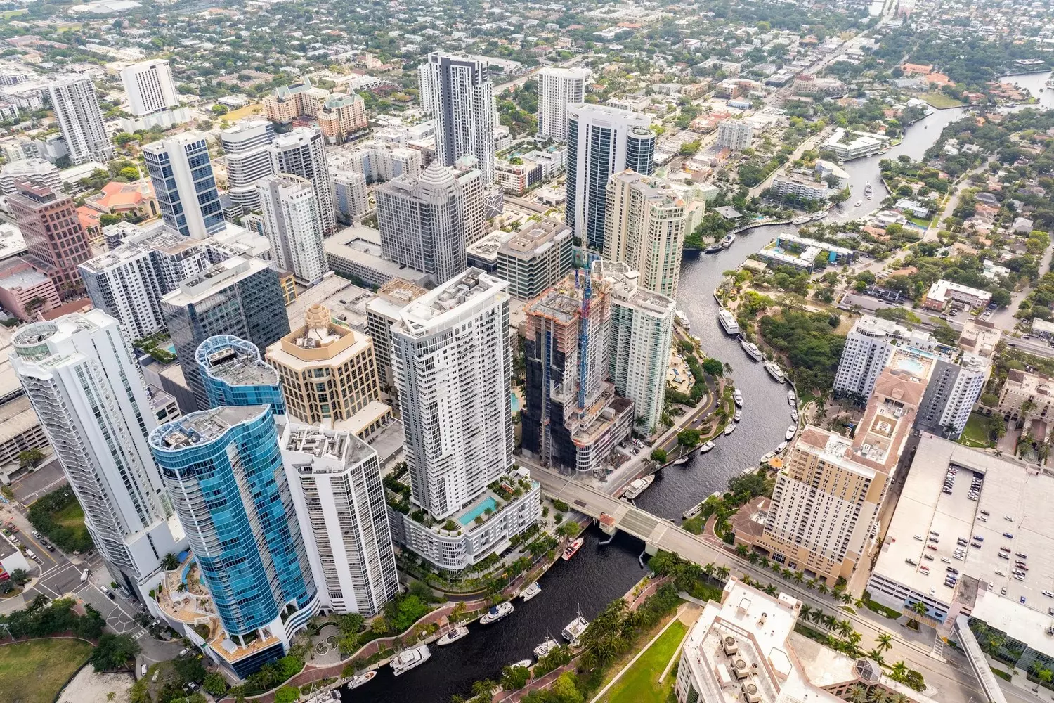 Bird's-eye panoramic view of downtown Fort Lauderdale's skyscrapers and canal system captured from a helicopter