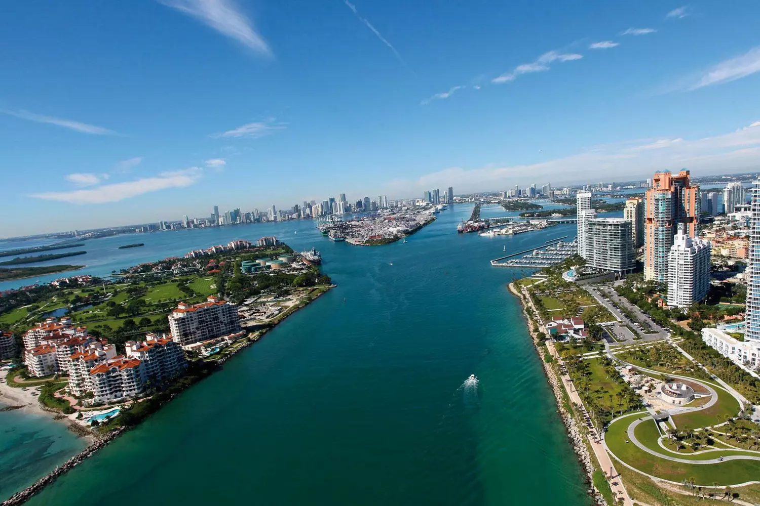 A breathtaking aerial view of the Miami coastline with high rise buildings and the bright blue ocean