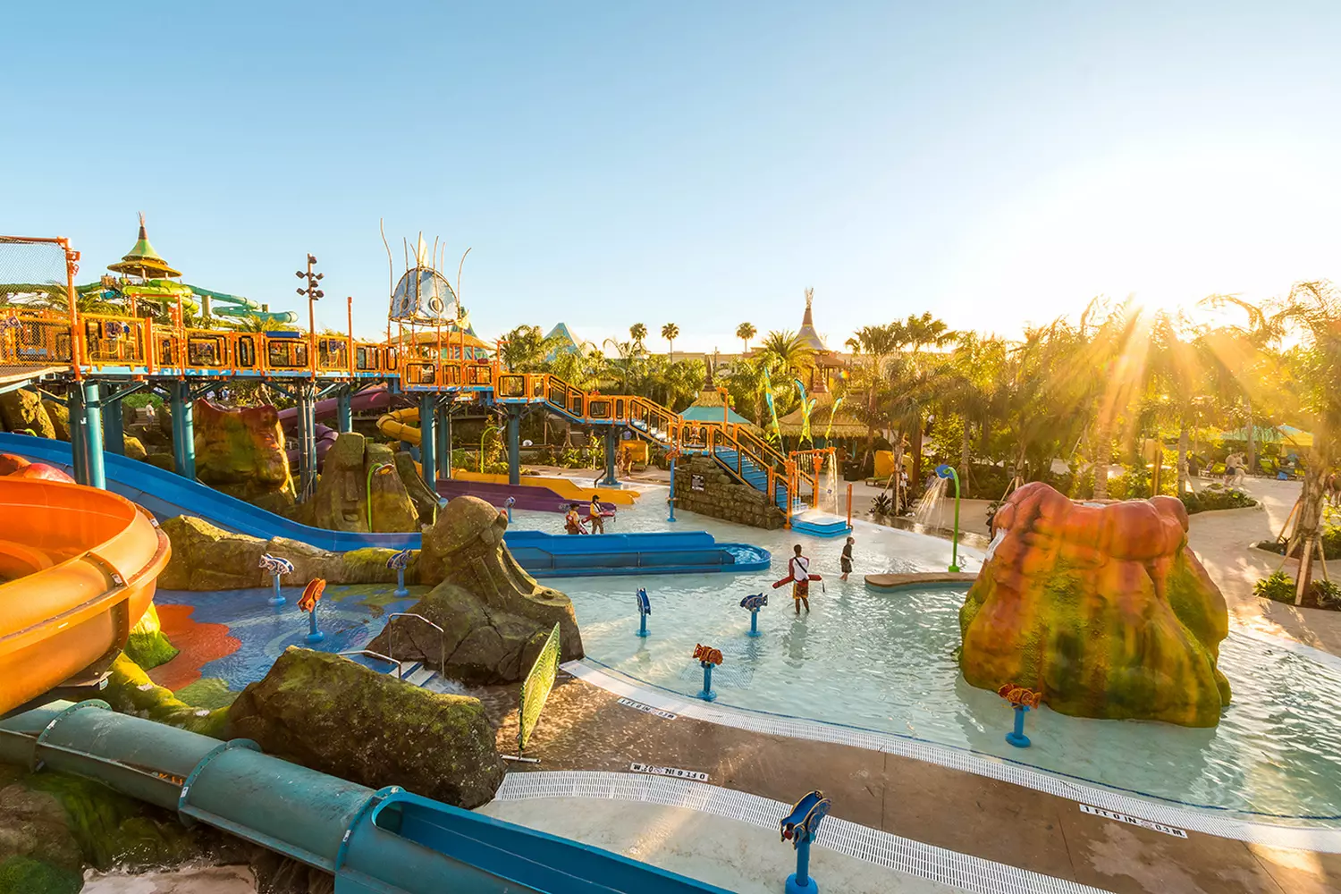 Safe and fun water adventures for children at Runamukka Reef in Volcano Bay Kids’ play area at Volcano Bay with mini slides and splash fountains