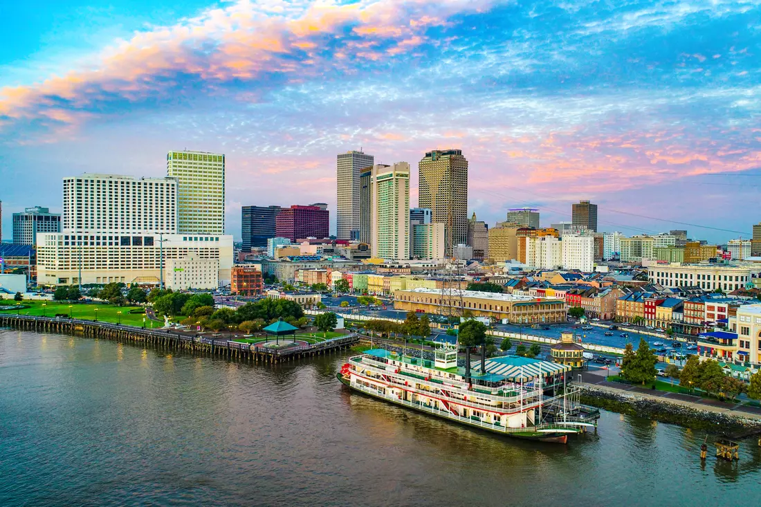 Panorama of downtown New Orleans with views of the waterfront and a riverboat on the Mississippi River