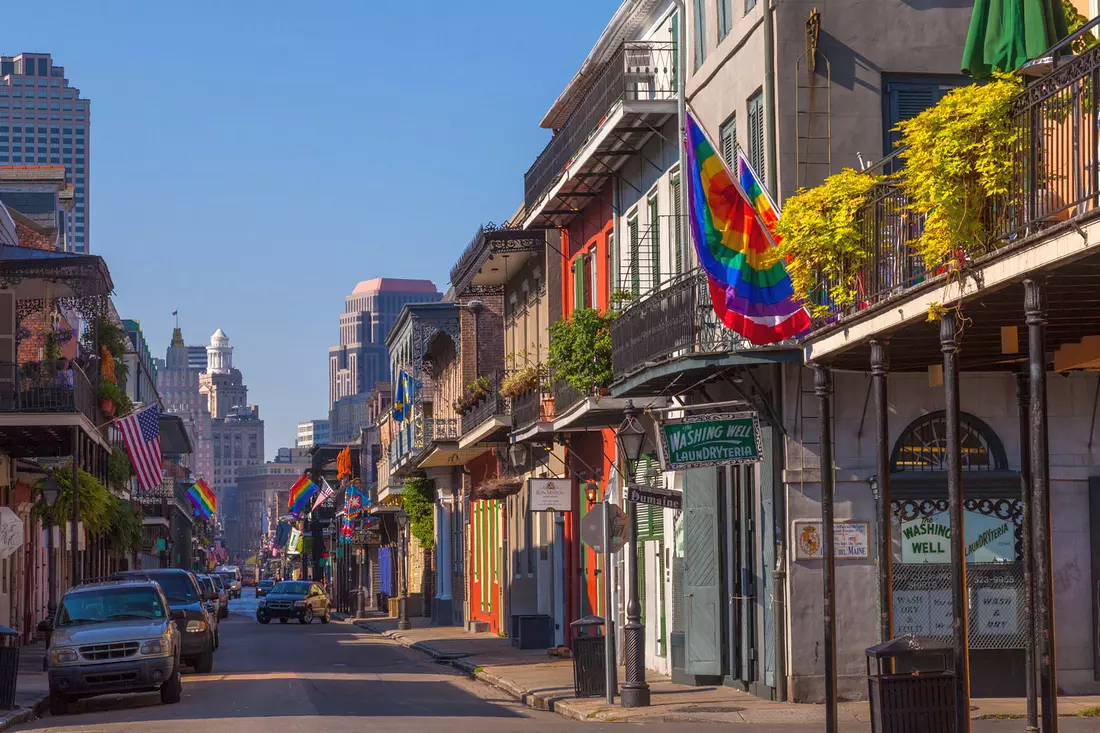 The French Quarter in New Orleans with colorful buildings and flags