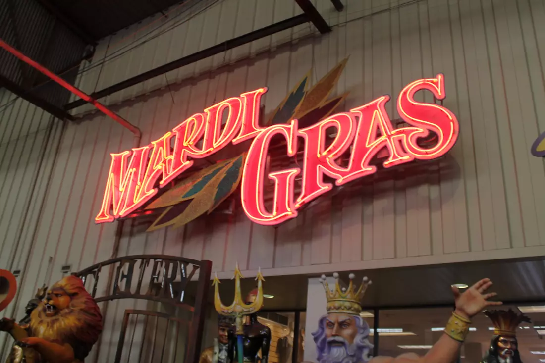 Neon Mardi Gras World sign above the entrance