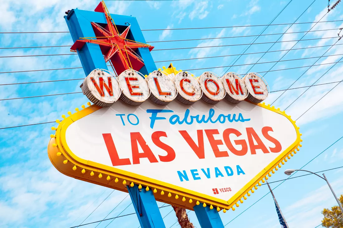 Iconic Welcome to Fabulous Las Vegas sign under a bright blue sky