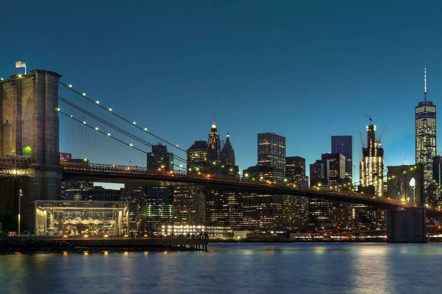 Iconic NYC Skyline: Manhattan and the Brooklyn Bridge at Golden Hour Stunning view of Manhattan's skyline and the Brooklyn Bridge, bathed in warm sunset light over the East River