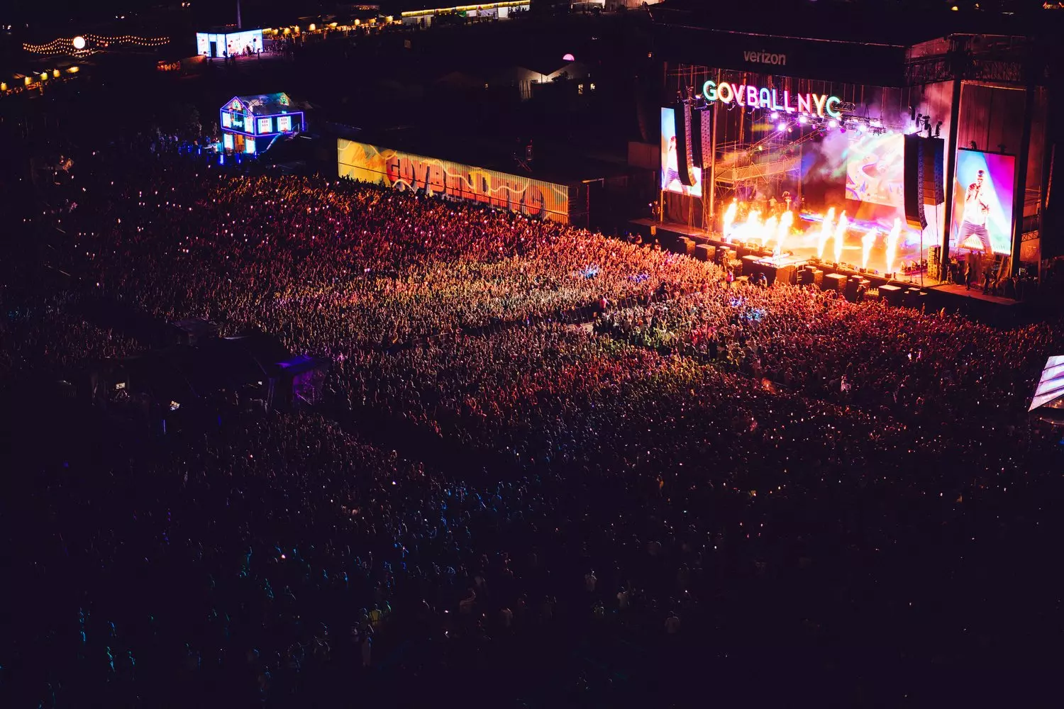 Illuminated stage and crowd at Governors Ball in New York City at night