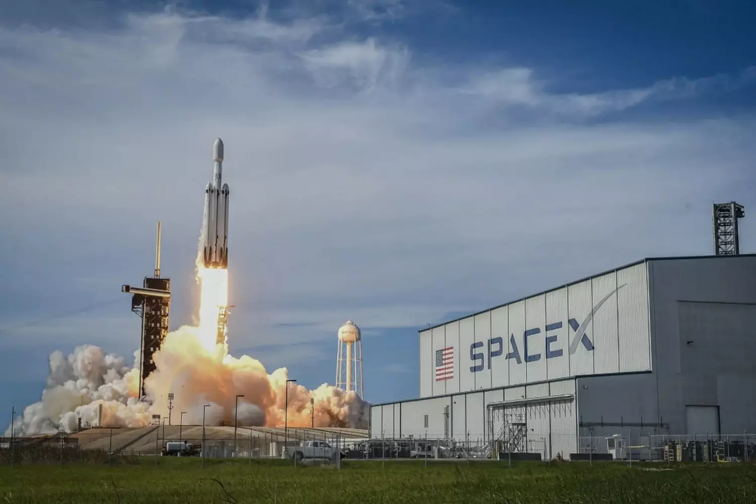Lone Star Liftoff: SpaceX Rocket Soars Over Texas A SpaceX Starship or Falcon rocket launching from Boca Chica, Texas, with massive plumes of fire and smoke against a dramatic sky, as the spacecraft ascends toward orbit