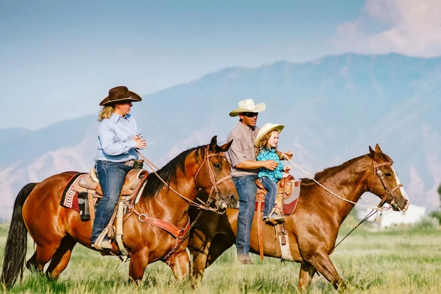 True Texas Spirit: Cowboy Family Riding Through the Lone Star State A multi-generational cowboy family on horseback, wearing classic Stetson hats and boots, riding across golden Texan prairie under vast open skies