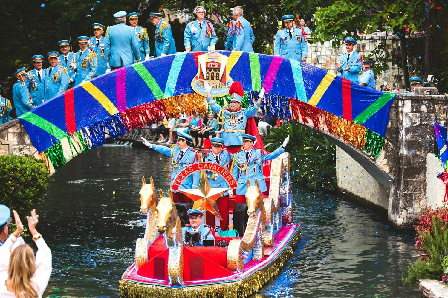 Viva Fiesta! San Antonio's Explosion of Color & Culture Joyful crowd in vibrant costumes during Fiesta San Antonio parade, with confetti showers, flower-decked floats, and the iconic Battle of Flowers procession along downtown streets