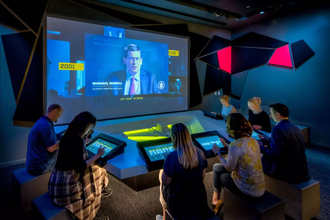 Group of people at an interactive exhibit in the International Spy Museum