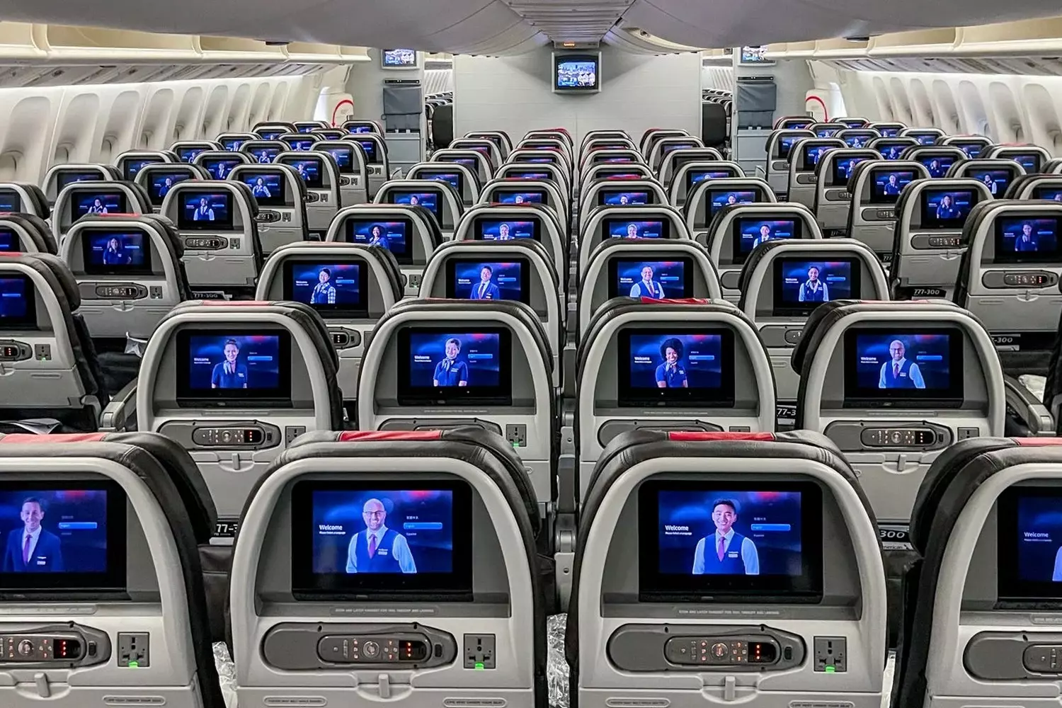 American Airlines cabin interior with comfortable seating and modern design Spacious and modern interior of an American Airlines passenger aircraft showing clean seats and ample legroom