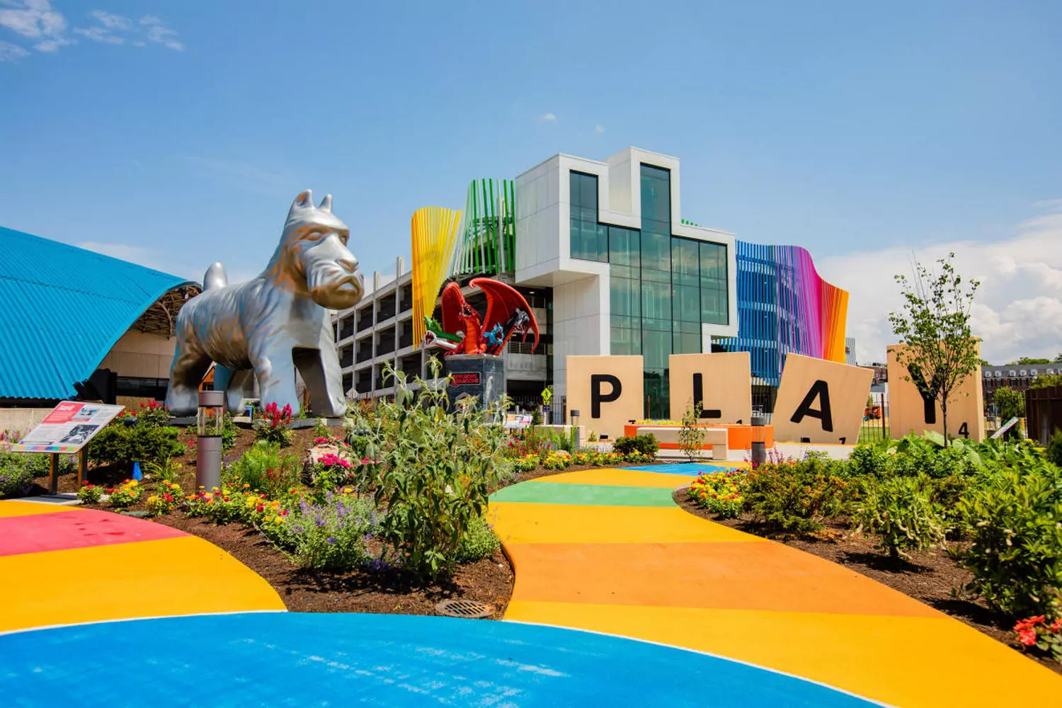 World's Premier Play Museum: The Strong National Museum of Play Panoramic shot of the museum's entrance featuring playful design elements, family-friendly landscaping, and the distinctive building structure dedicated to the history of play
