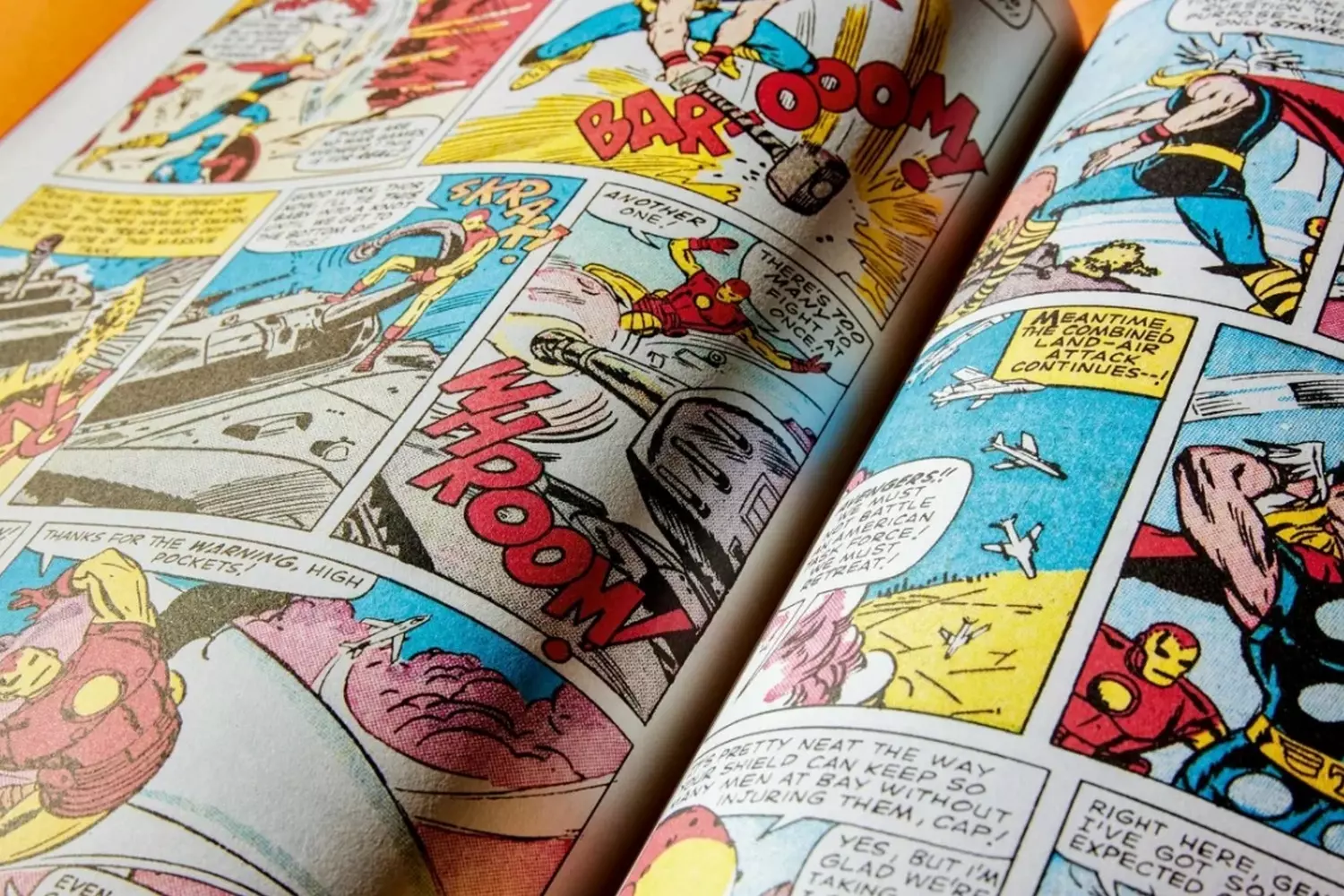 Vintage Comic Book Pages: Art in Sequence A collage of vintage comic book pages spread out, showing colorful panels with classic superhero action sequences and speech bubbles from American comics