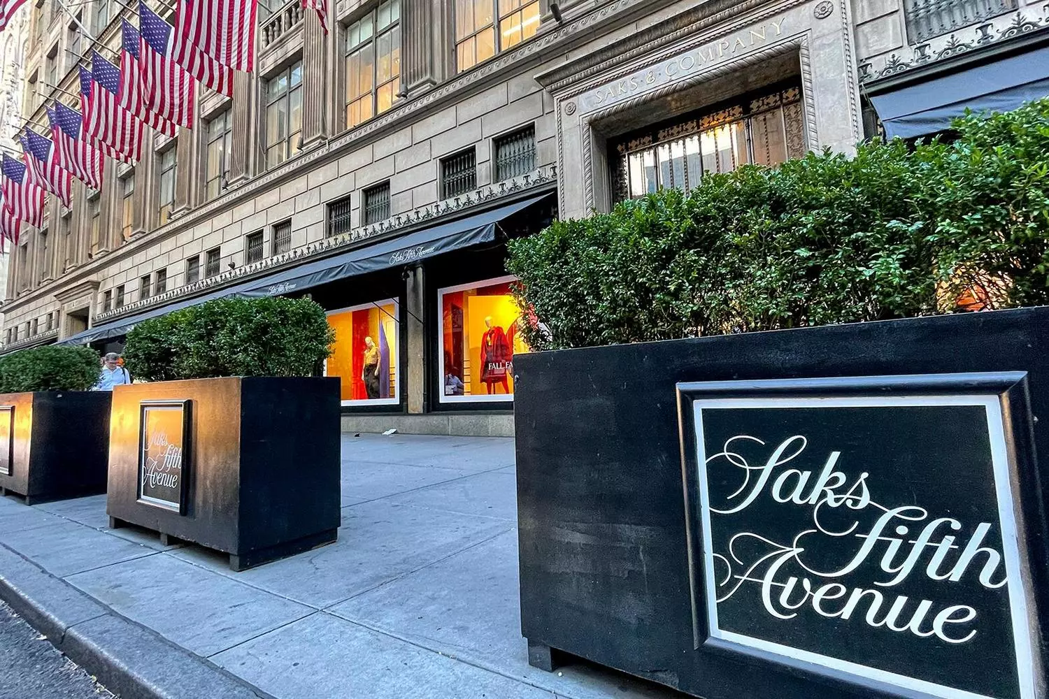 Saks Fifth Avenue: эталон роскошного шопинга в Нью-Йорке Роскошный интерьер флагманского магазина Saks Fifth Avenue с дизайнерскими бутиками, сверкающими люстрами и элегантными покупателями, рассматривающими коллекции люксовых брендов на легендарной Пятой авеню