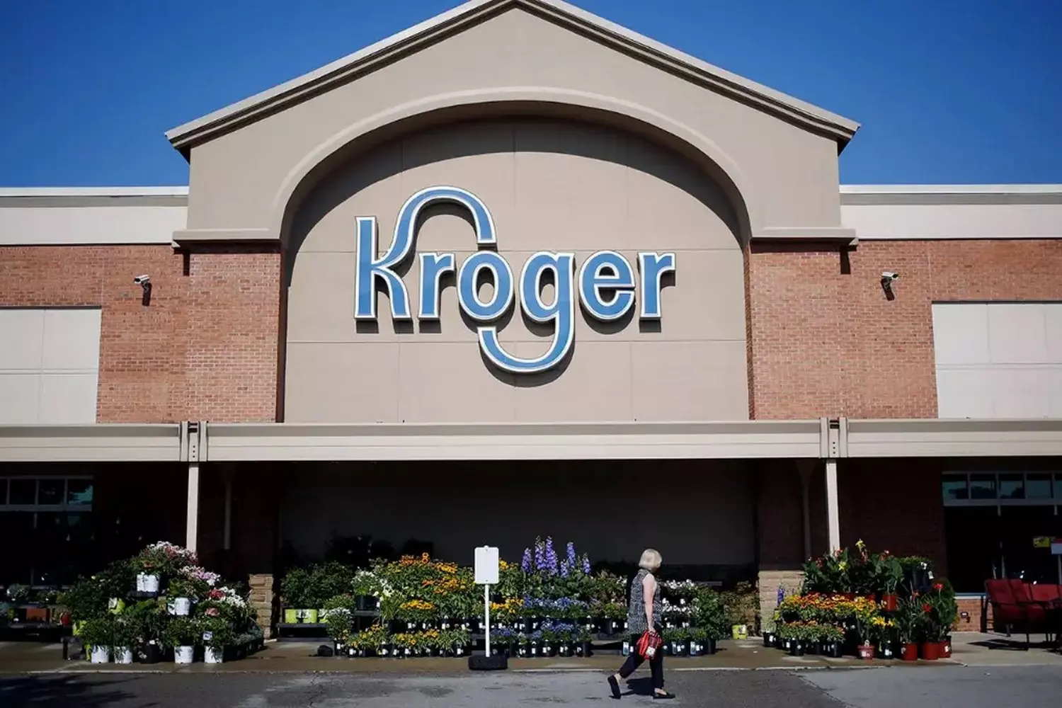 Kroger USA: A Look at America's Largest Grocery Chain Exterior view of a classic Kroger supermarket in the USA, featuring the signature red and white branding, spacious parking lot, and welcoming entrance with shopping carts lined up outside