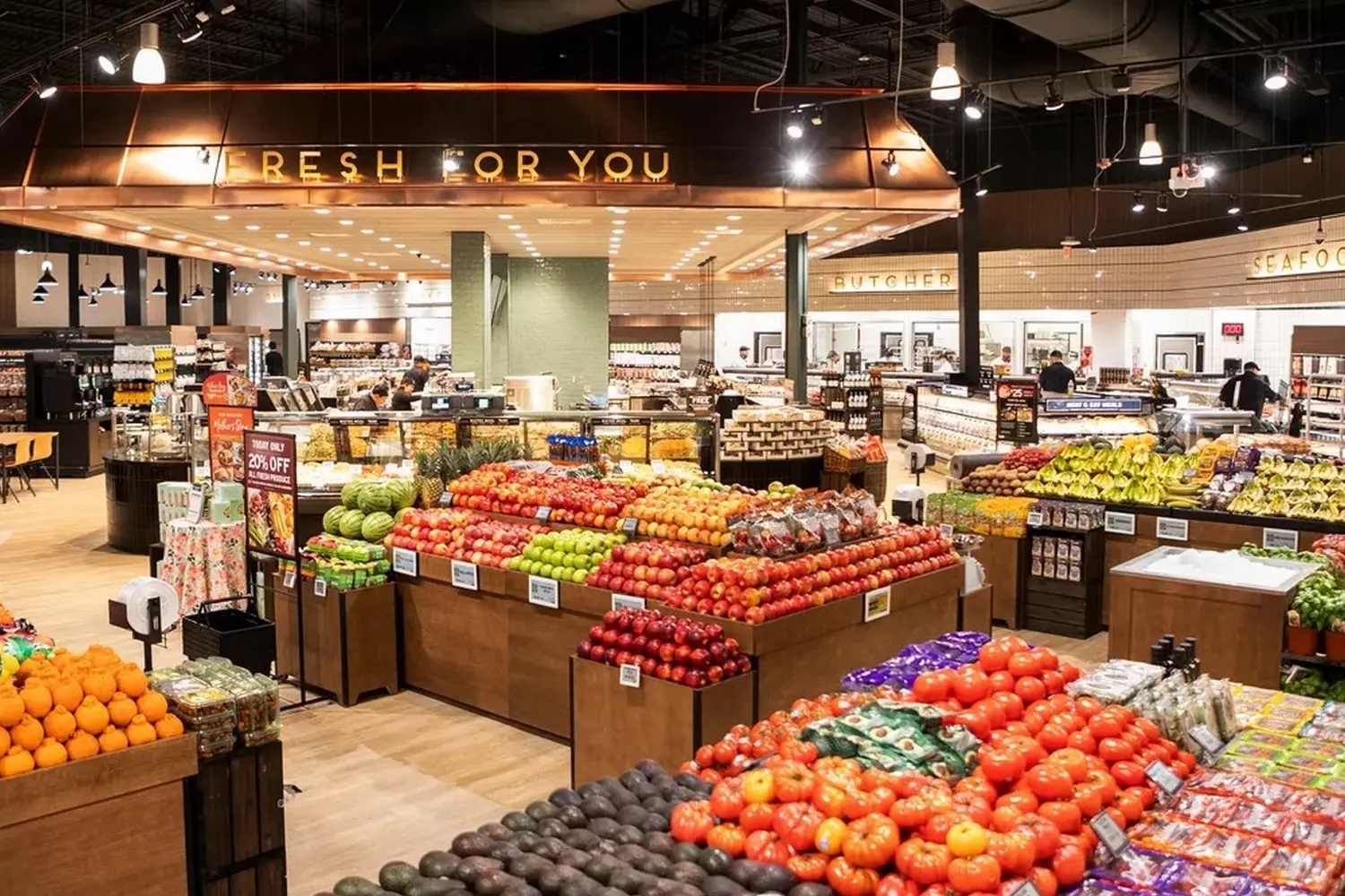 Inside The Fresh Market USA: A Gourmet Grocery Experience Elegant interior of The Fresh Market grocery store featuring artisanal food displays, fresh produce in wooden crates, and the store's signature upscale market atmosphere with warm lighting and rustic decor