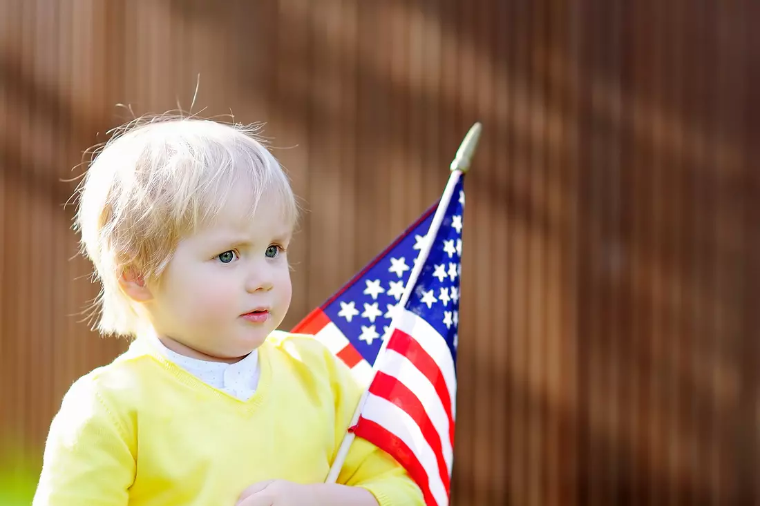 Child with American flag symbolizing the future and the American Dream