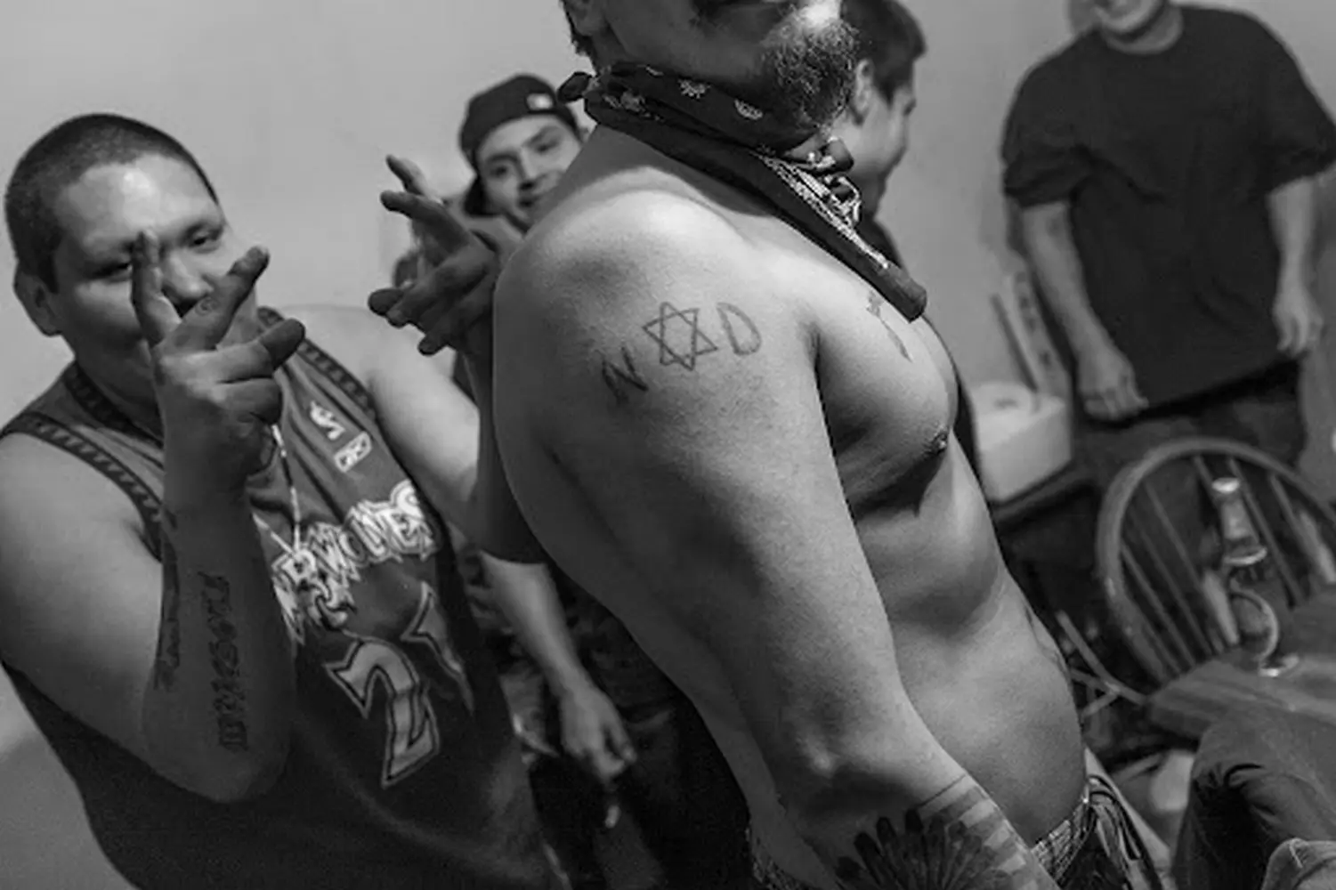 Шестиконечная звезда: Gangster Disciples отмечают свою территорию Члены банды Gangster Disciples собрались в чикагском квартале, демонстрируя характерные жесты шестиконечной звезды