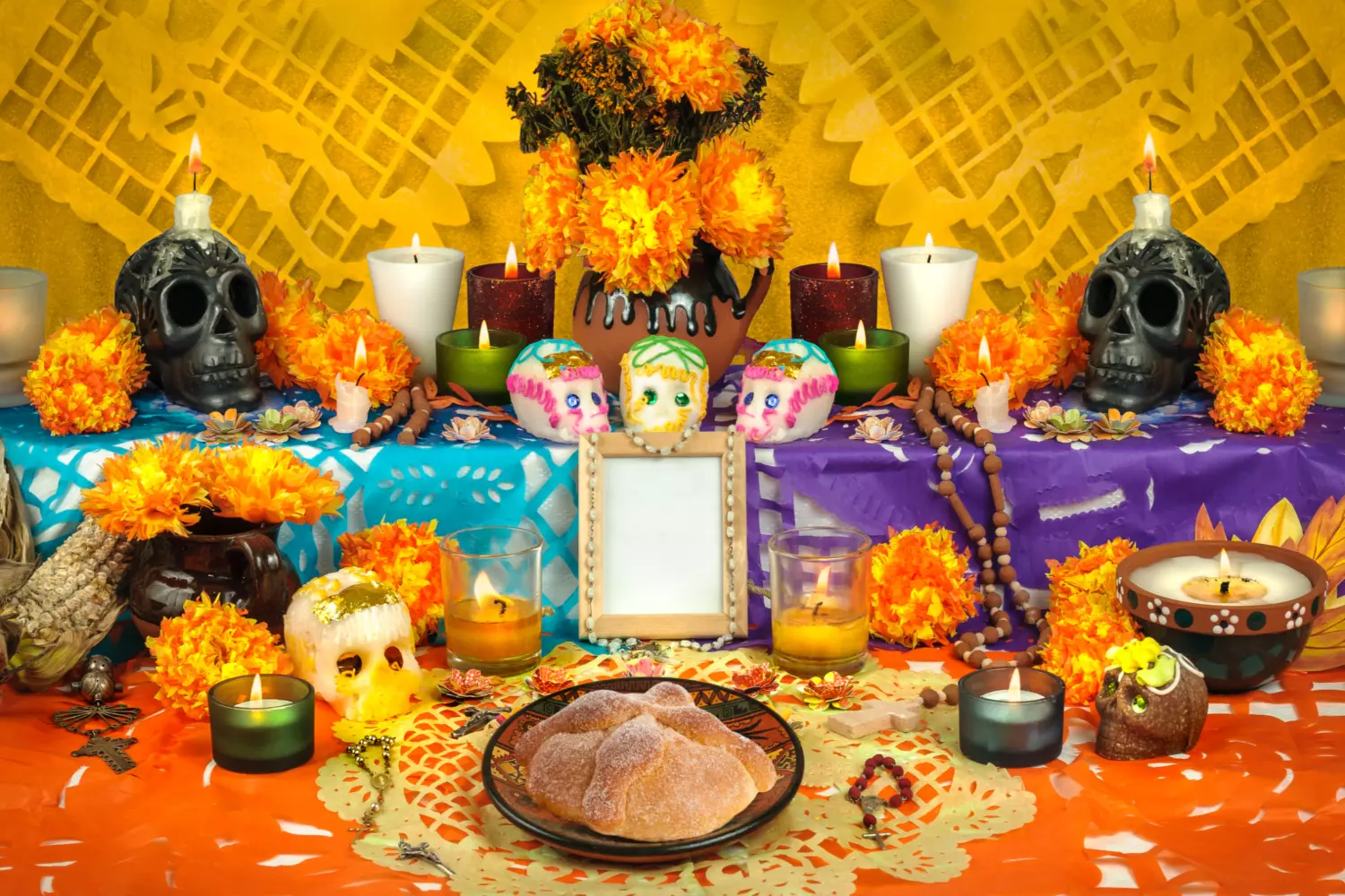 Vibrant Traditions: Celebrating El Día de Muertos in Color Colorful Día de Muertos altar decorated with marigolds, sugar skulls, candles, and photos of loved ones, showcasing Mexican tradition of honoring the deceased