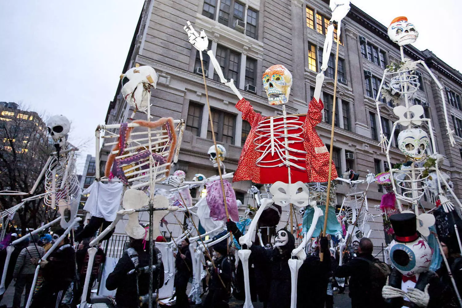 New York's Halloween Spectacle: Village Parade Comes Alive Colorful nighttime scene of NYC's Village Halloween Parade with massive puppets, extravagant costumes, and thousands of spectators lining 6th Avenue for the world's largest Halloween procession