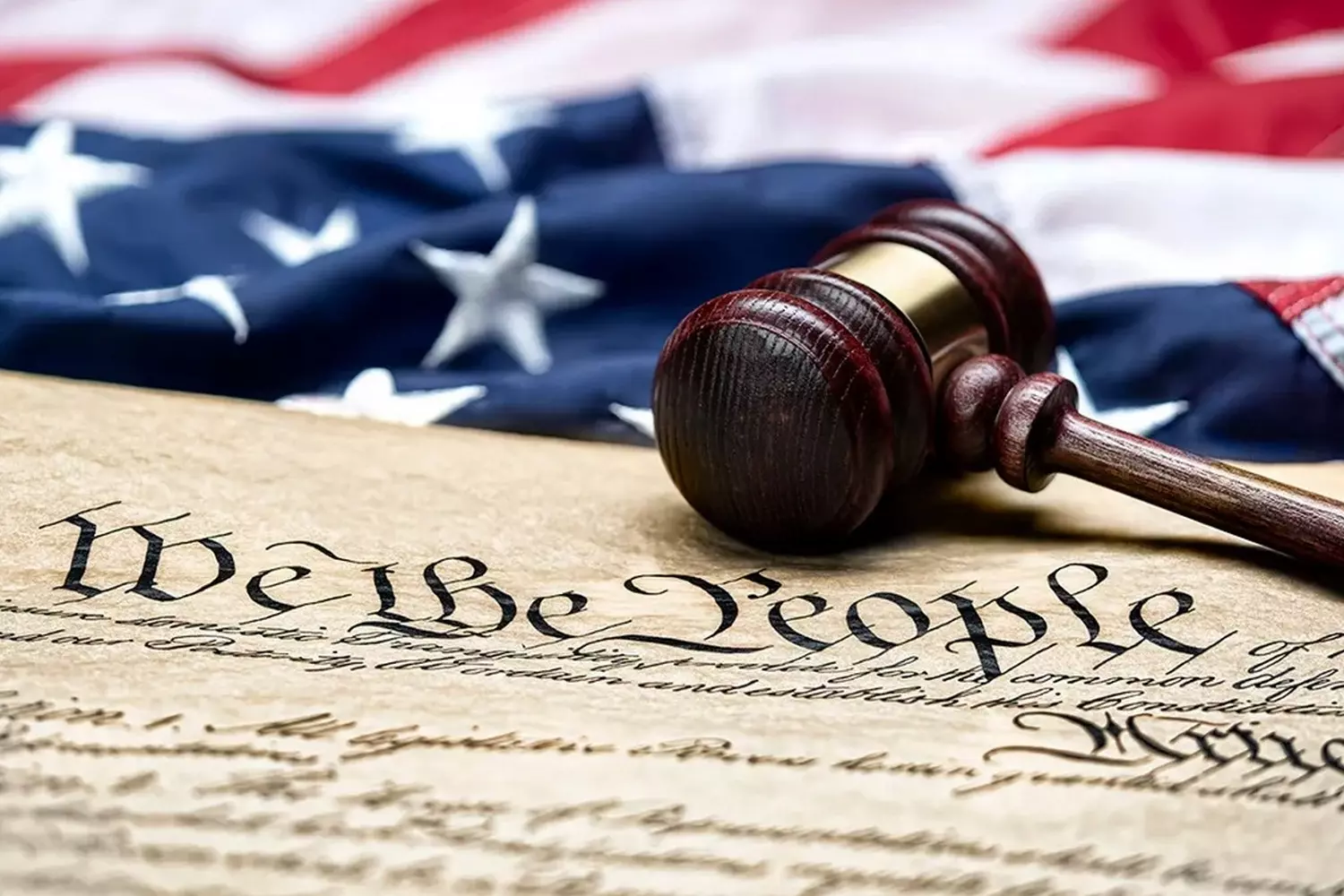 Gavel on the text of the US Constitution — symbol of justice and the rule of law A judge's gavel resting on a page of the handwritten or printed United States Constitution, symbolizing the rule of law and judicial authority