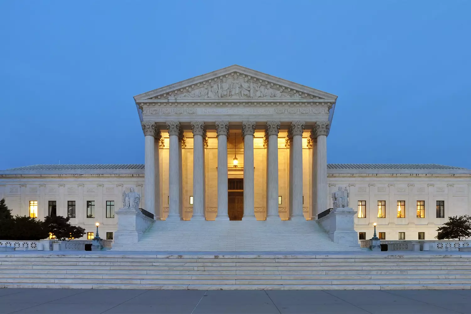 The US Supreme Court Building — temple of justice The white marble facade of the US Supreme Court Building, with wide steps leading to the main entrance and allegorical statues flanking the sides