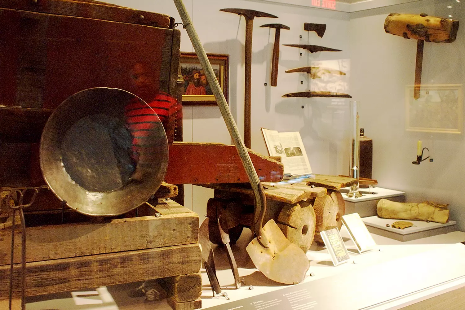 Tools of the Gold Rush: Witnesses of an Era of Adventurers An exhibit in a museum showcasing authentic tools used by gold prospectors: pickaxes, pans, scales, and other equipment from the mid-19th century California Gold Rush