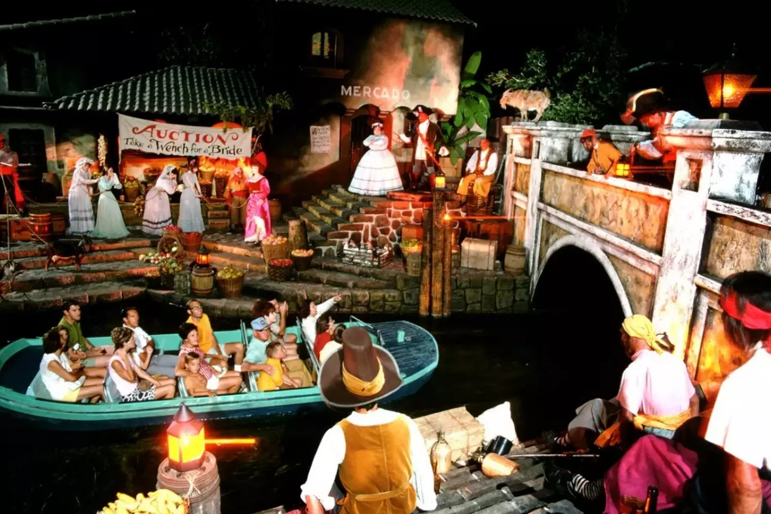 Pirates of the Caribbean Ride: Immersive Adventure with Jack Sparrow at Disneyland Visitors in a boat ride through pirate battle scenes at the Pirates of the Caribbean attraction in Disneyland, featuring audio-animatronic figures, a burning town, and pirate ships