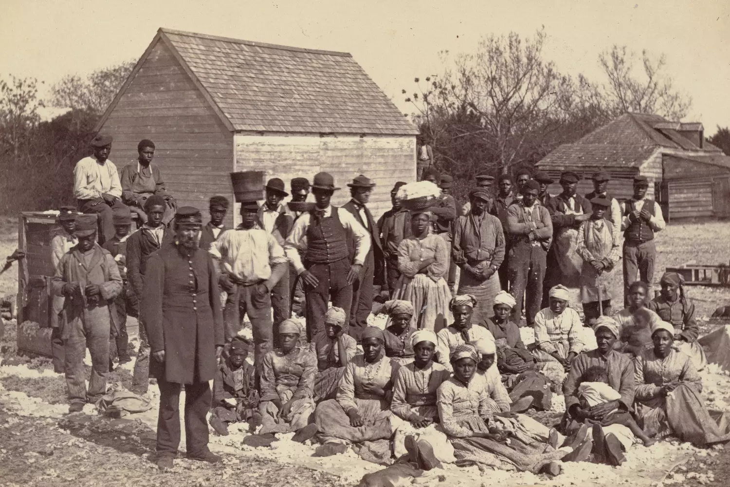 Enslaved African Americans at a plantation house in the USA — 19th-century image A group of enslaved African Americans in front of a house on a plantation in 19th century America, illustrating the harsh living conditions of slavery