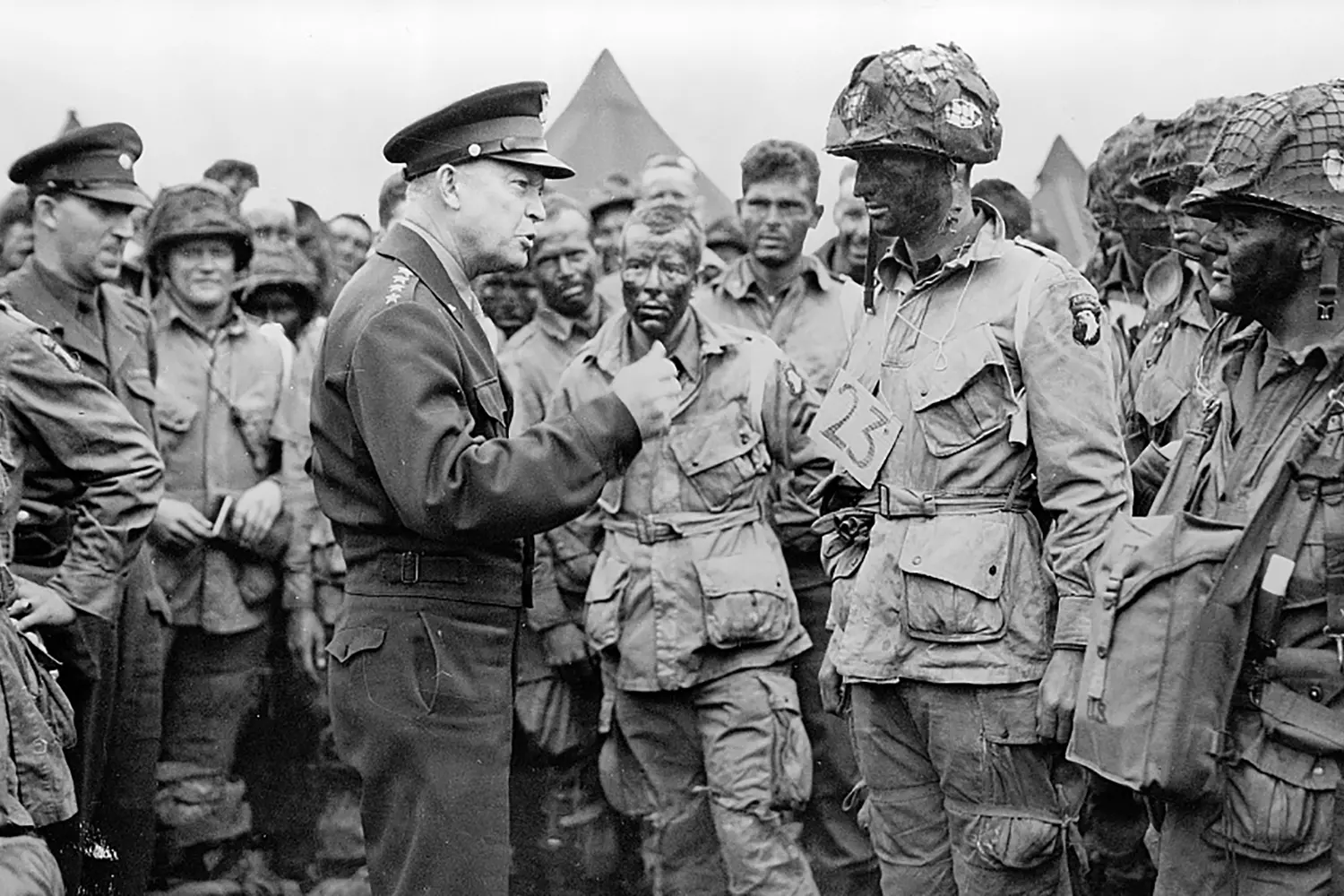 General Eisenhower Instructing a Soldier in the European Theater Supreme Allied Commander Dwight D. Eisenhower in field jacket talking intently with a young GI somewhere in Europe