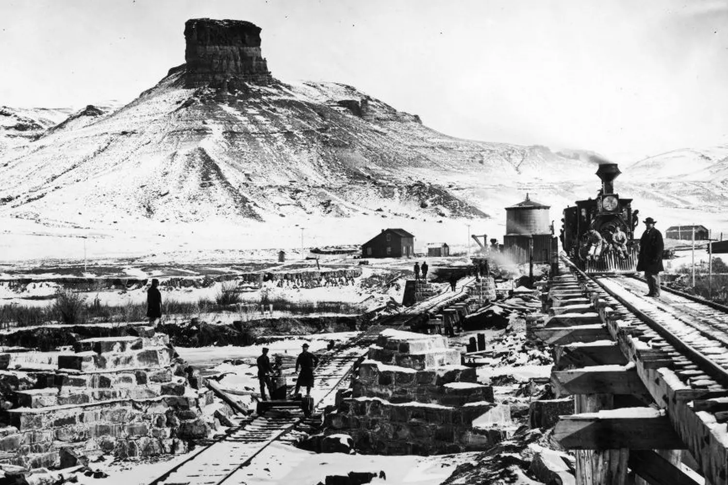 Historic Construction of the Transcontinental Railroad in the American Wild West Black and white photo showing the construction of the first transcontinental railroad