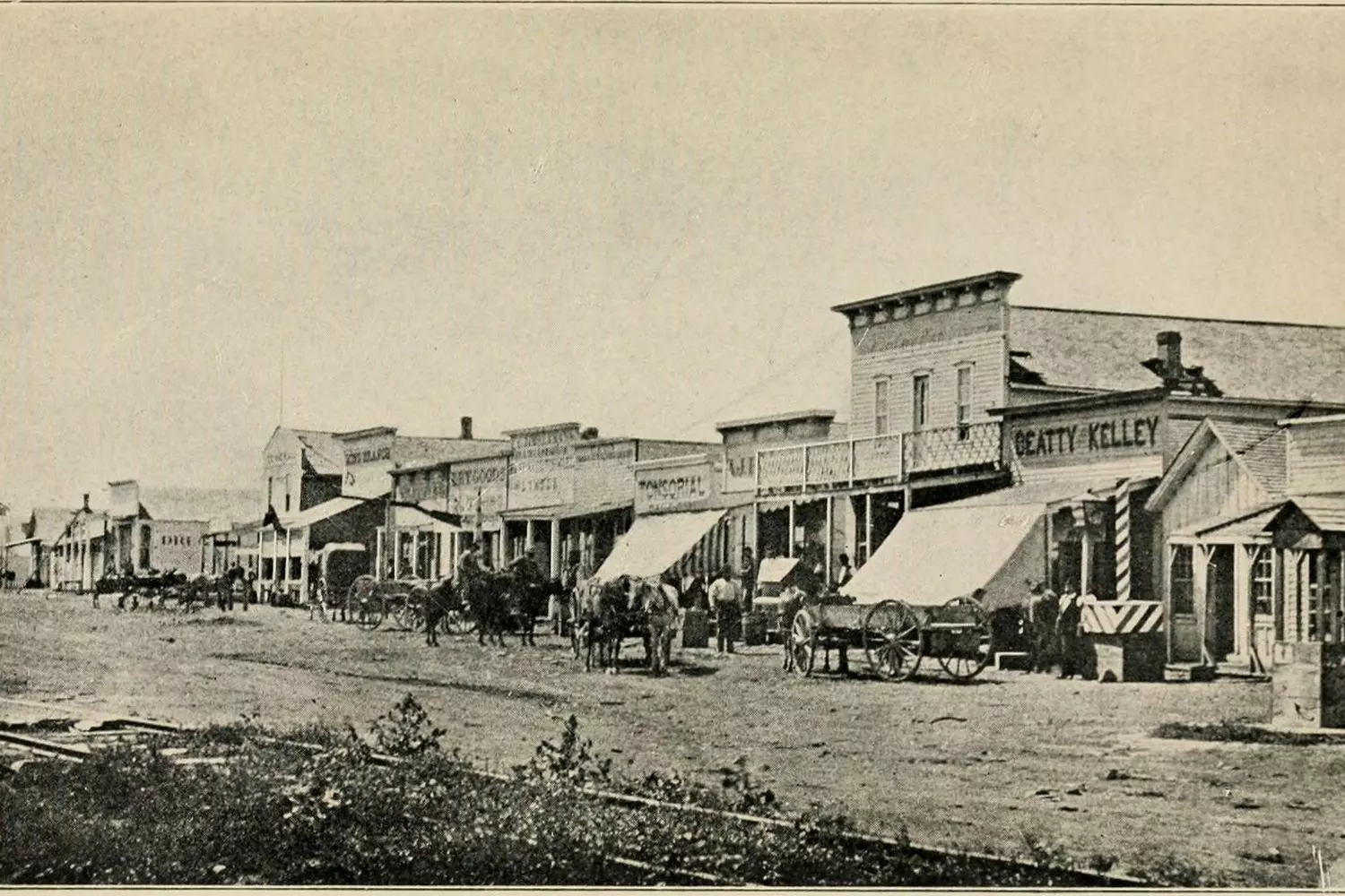 Wild Western Town — Journey into the Past A historic Wild West town with wooden buildings, saloons, and a dusty main street under a clear blue sky, evoking the atmosphere of the American frontier era