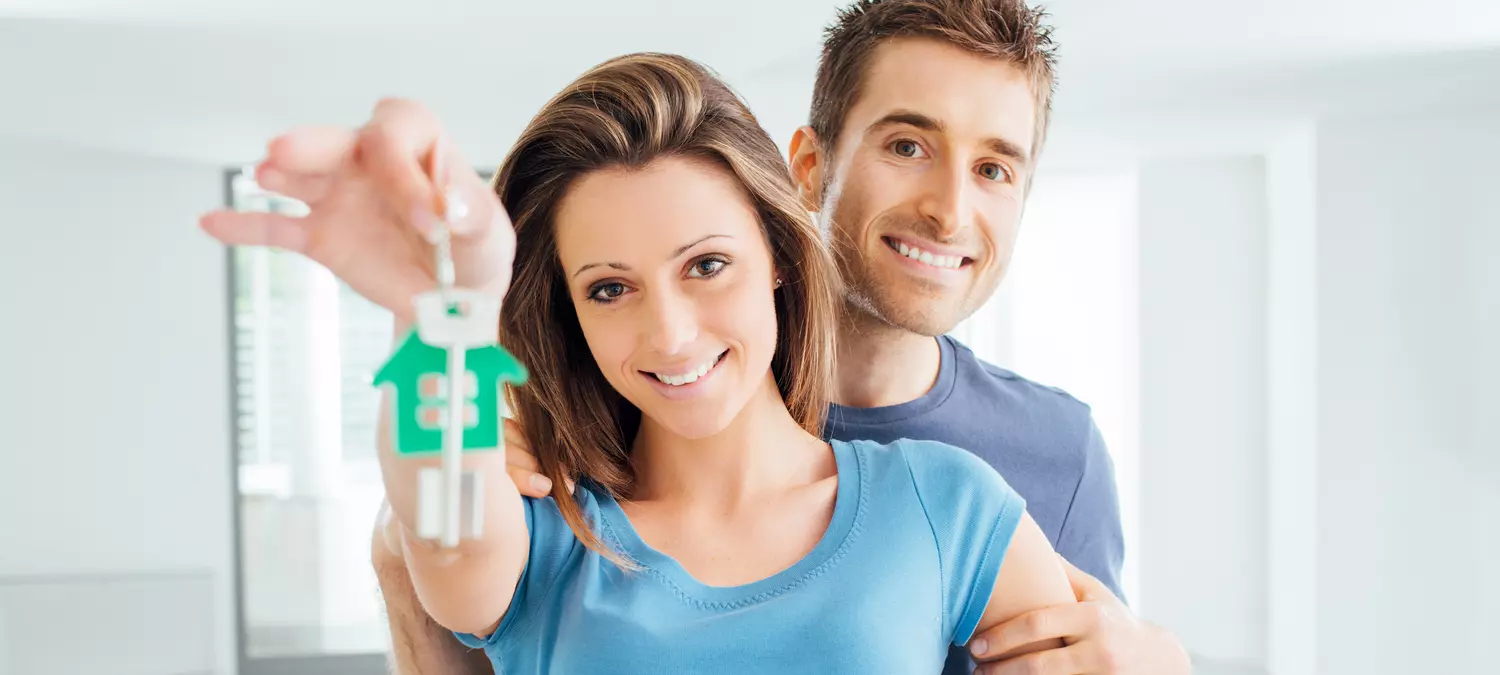 Miami Inexpensive Residential Property — Photo of a married couple holding keys to a new home — American Butler