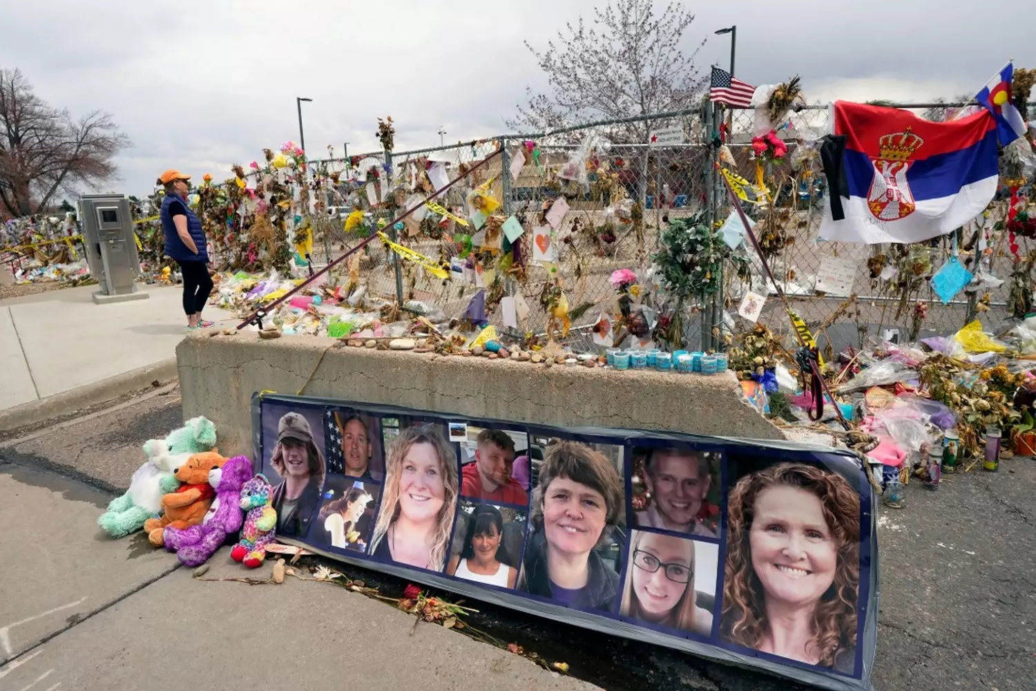 A Makeshift Shrine: Community Gathers to Remember Lives Lost to Gun Violence A spontaneous memorial with flowers, candles, and handwritten notes left at the site of a mass shooting, as mourners pay their respects to the victims