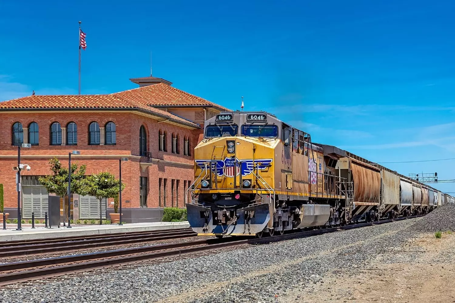 The Steel Artery of America: Power of Freight Shipping A long freight train in the USA with a CSX or Union Pacific locomotive hauling containers and tank cars on the mainline