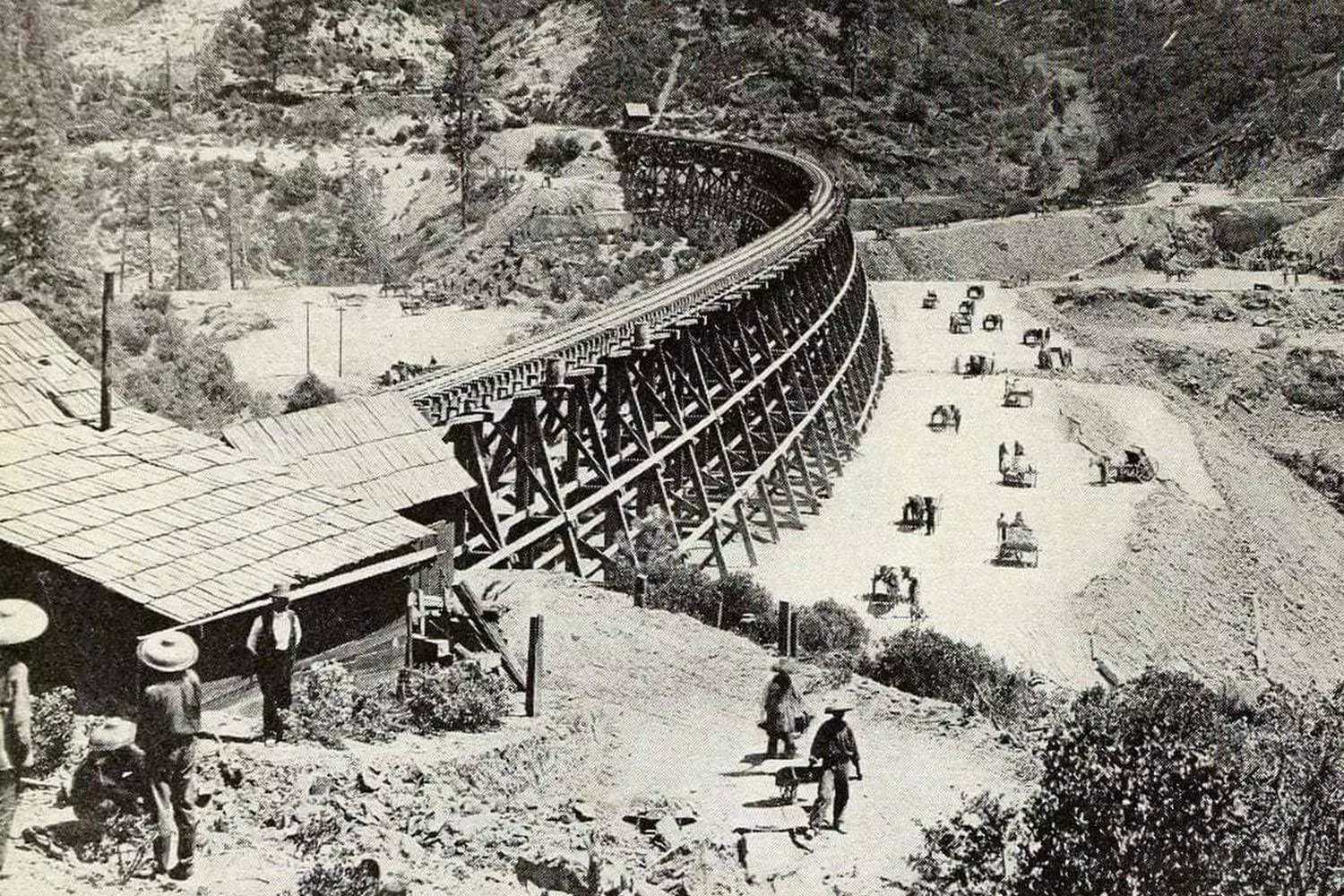The Great Enterprise: How America Was Connected by Rails Historic black and white photo: construction of the First Transcontinental Railroad in the USA in the 1860s, workers laying tracks in the mountains