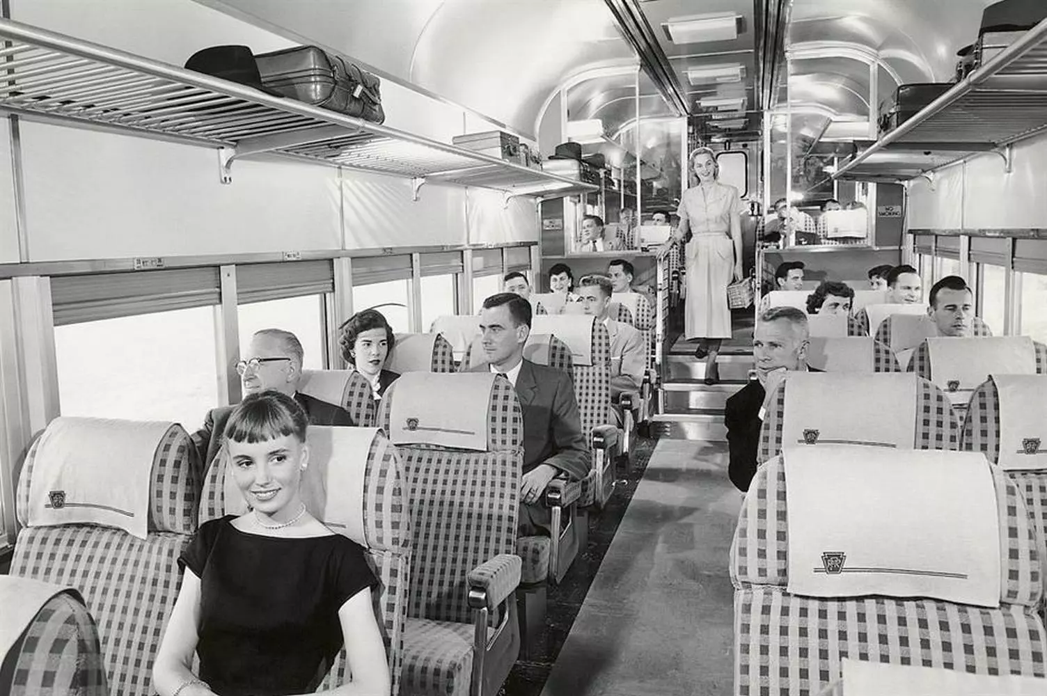Luxury on Rails: A Journey to the Golden Era of 1950s American Trains Interior or exterior of a 1950s US passenger streamliner train car: luxurious seats, wood paneling, large windows
