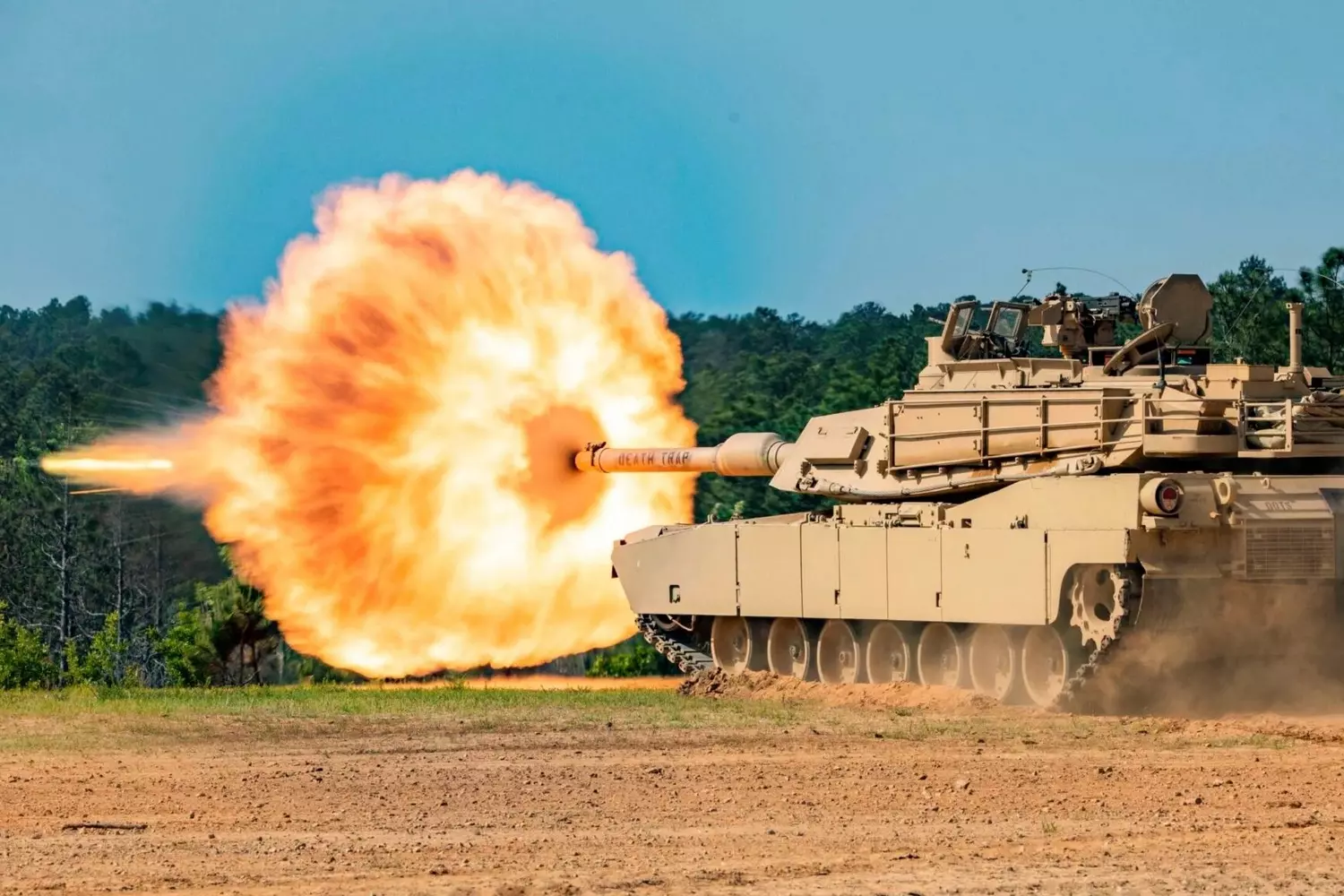 The M1 Abrams main battle tank fires its 120mm smoothbore cannon during exercises, producing a powerful muzzle flash The M1 Abrams main battle tank fires its 120mm smoothbore cannon during exercises, producing a powerful muzzle flash